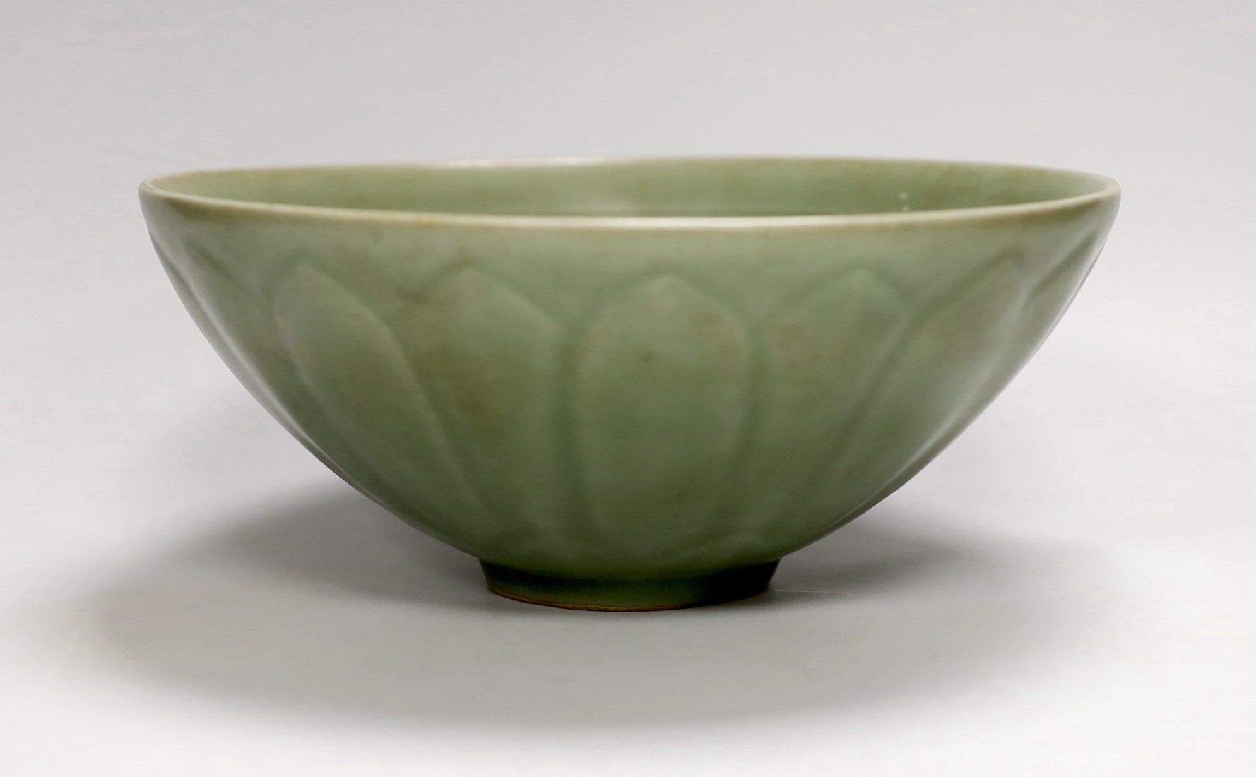 A Chinese celadon ground ‘lotus’ bowl, 21cm diameter